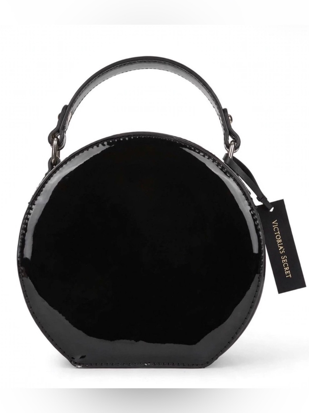 This is a black, round, patent leather-like handbag from Victoria's Secret.